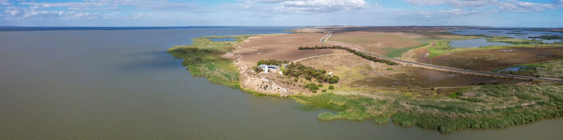 Aerial view of Point Malcom Lighthouse and Lake Alexandrina in a tranquil landscape, Meningie, South Australia, Australia.