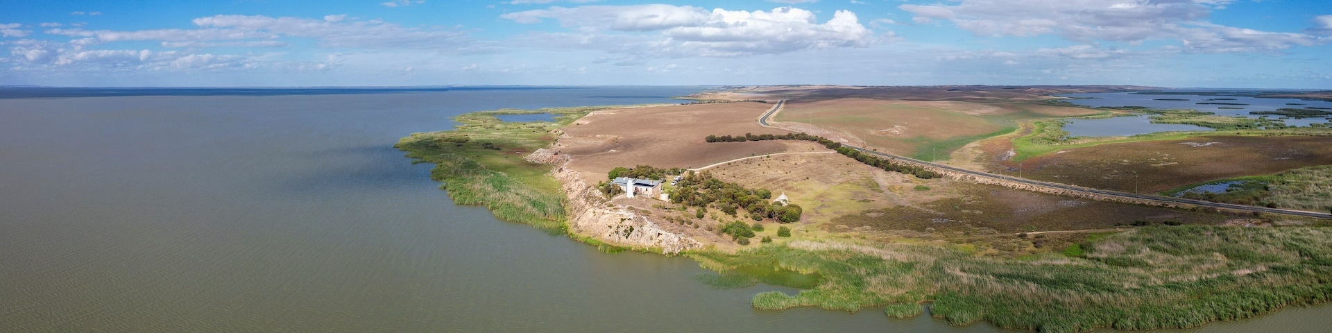 Aerial view of Point Malcom Lighthouse and Lake Alexandrina in a tranquil landscape, Meningie, South Australia, Australia.