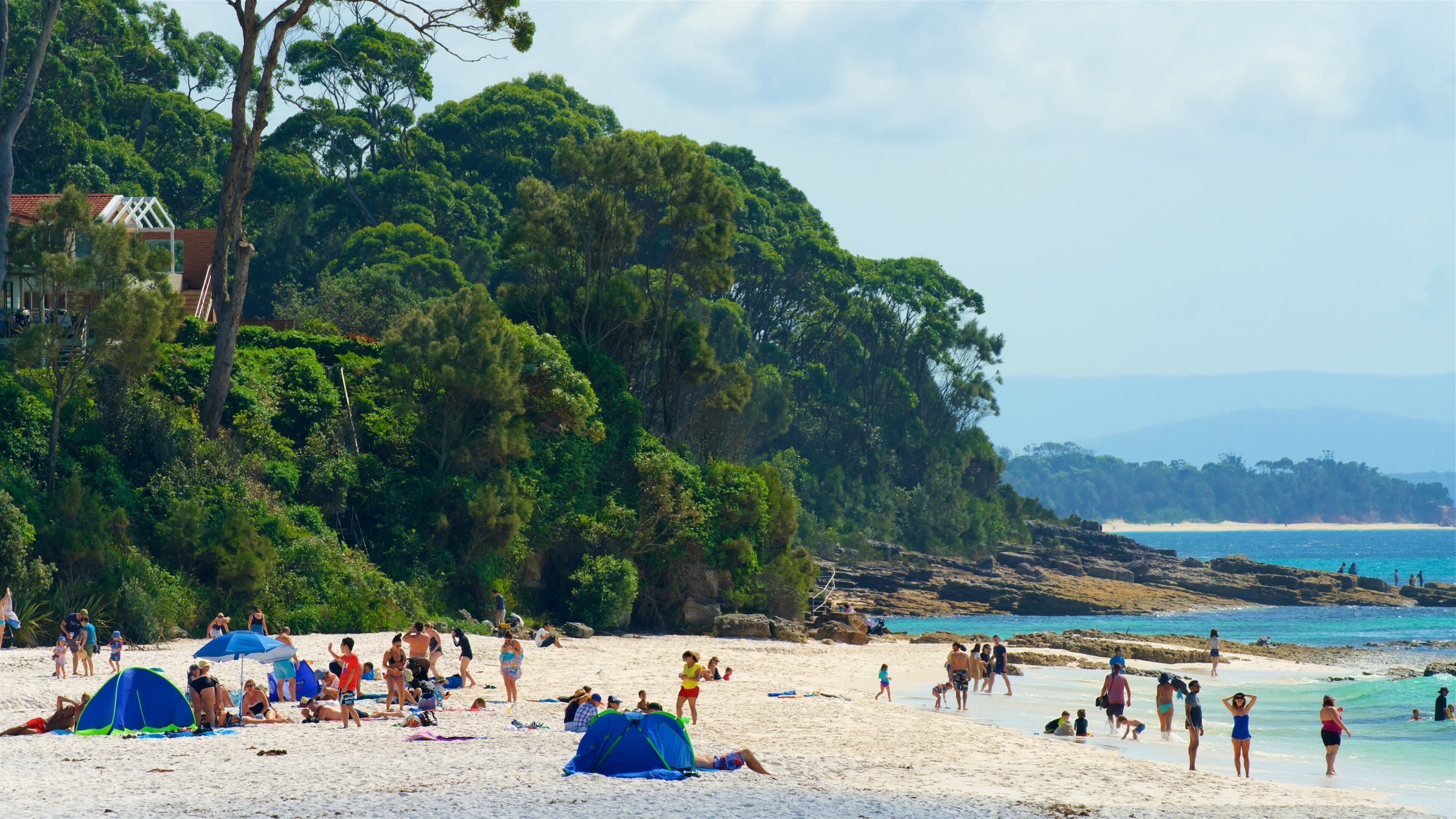 Hyams Beach which includes rocky coastline, general coastal views and a sandy beach