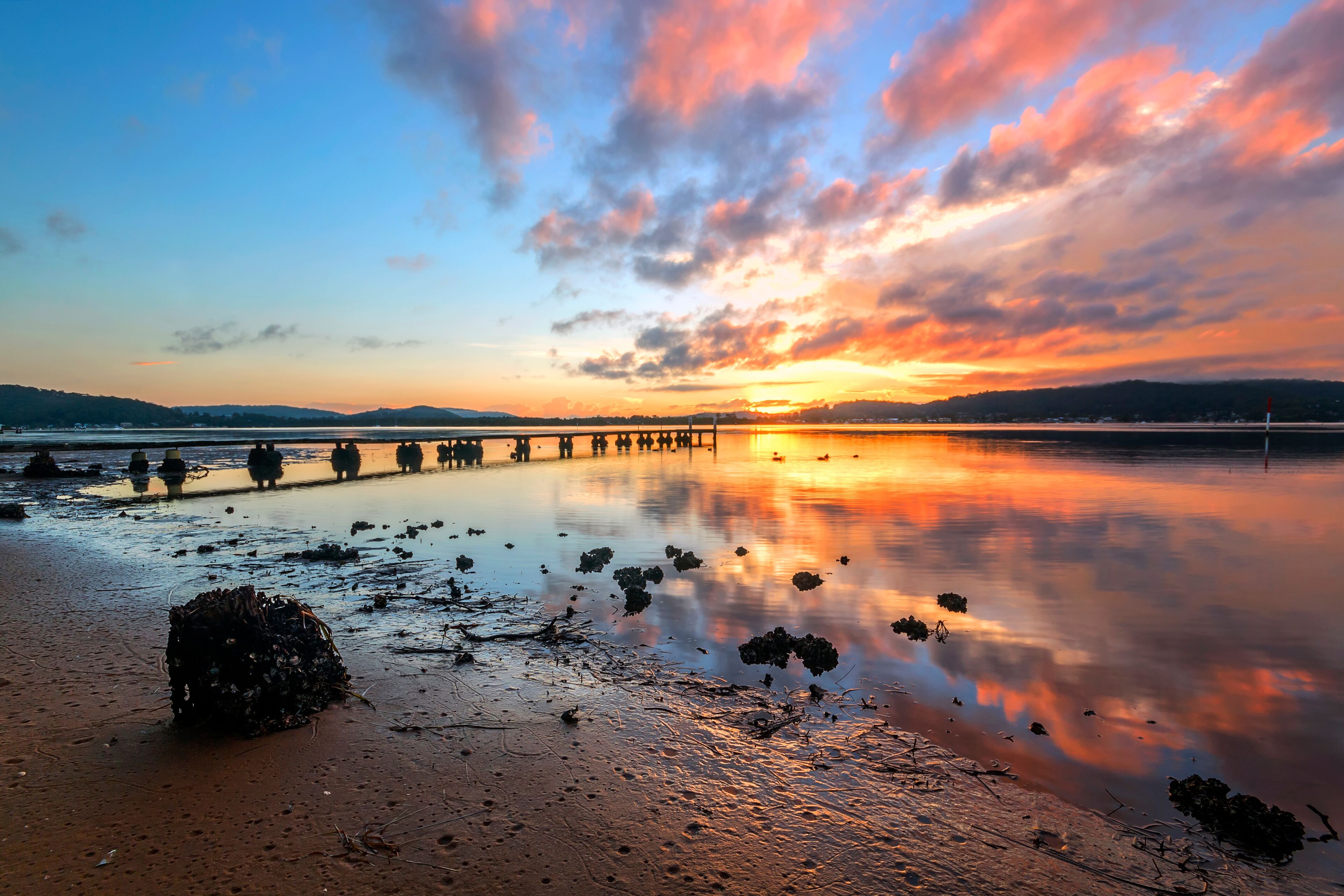 sunset over a body of water in woy woy on nsw central coast