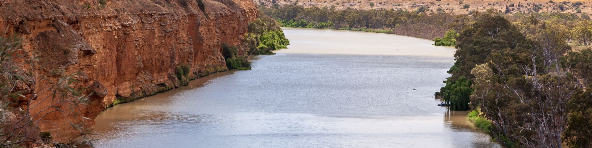 Landscape view of orange sandstone cliffs on the mighty Murray River near Young Husband in South Australia