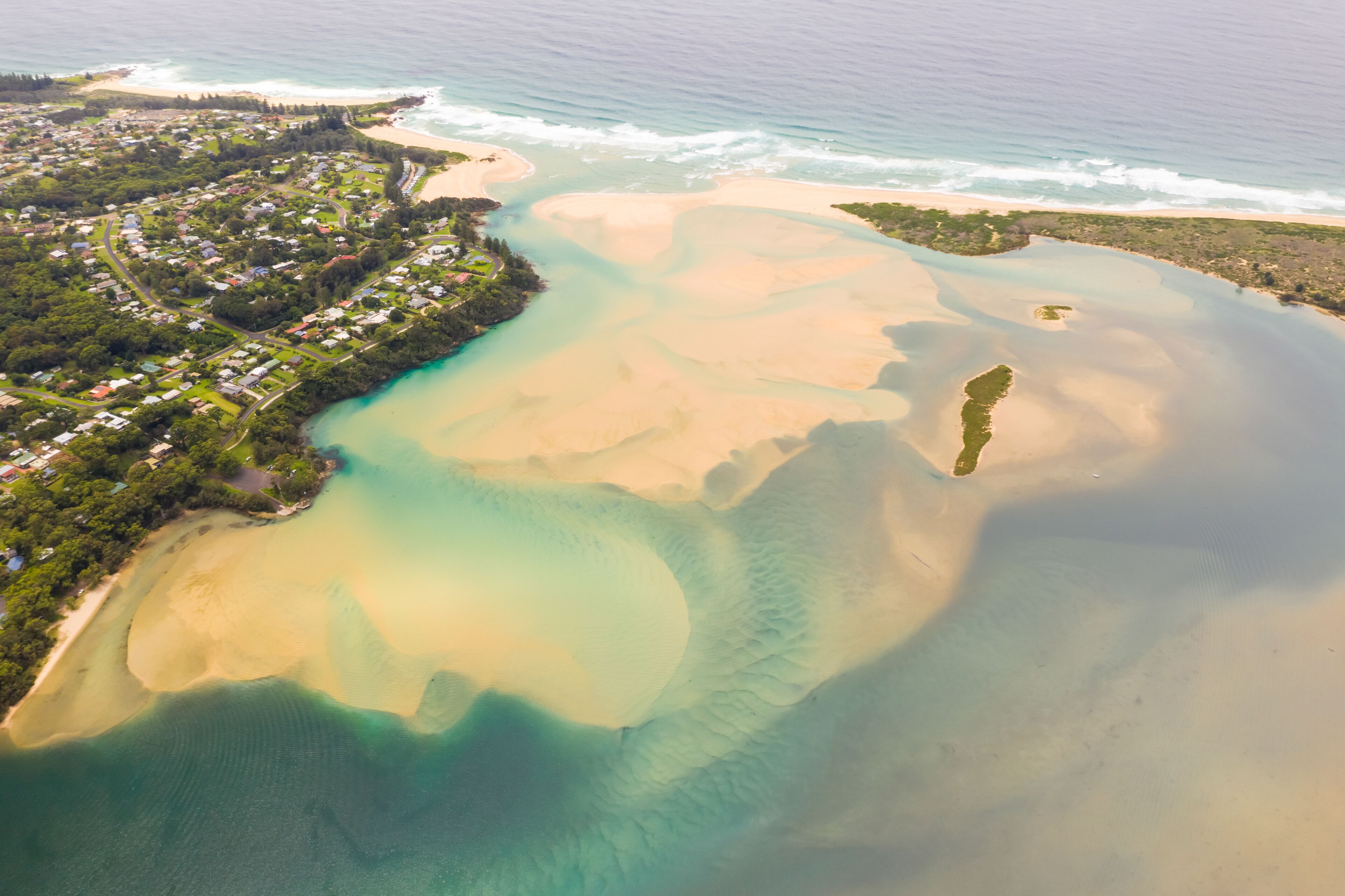 Aerial view of the river meets the sea near Tuross Head city, Australia.