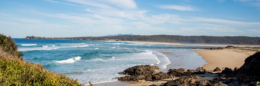 Ocean waves with white foam on a sunny day. Nature tropical paradise background. Tuross Head, NSW, Australia