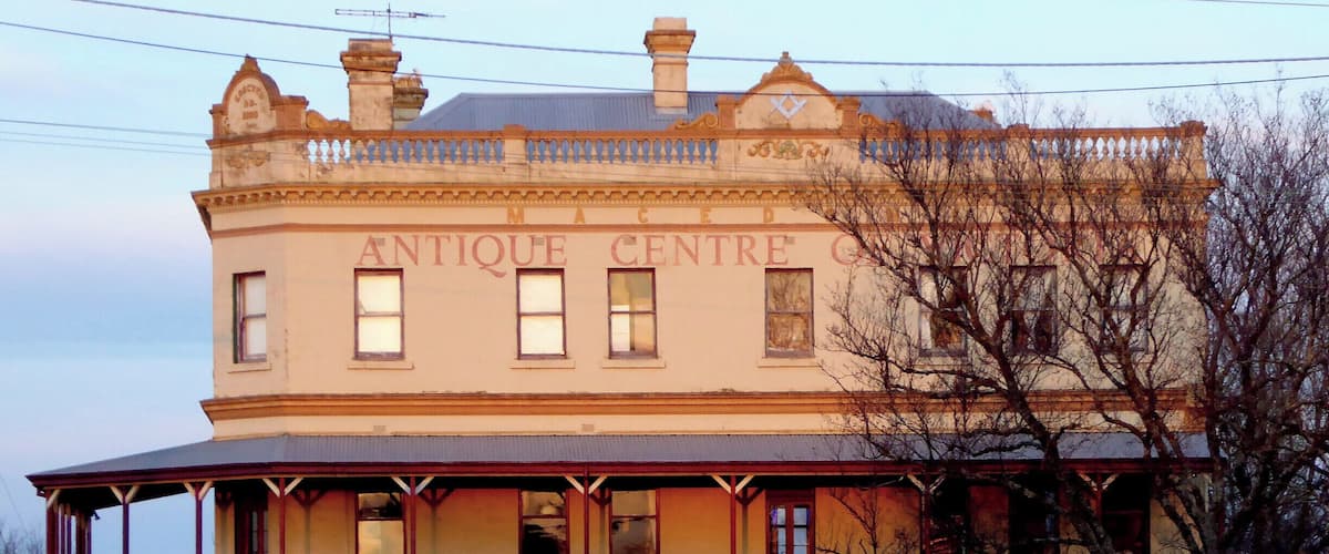A two-story building with the sign "ANTIQUE CENTRE" on the facade.