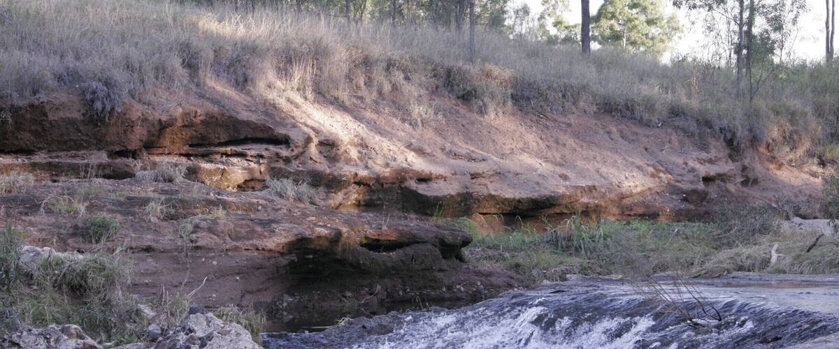 A rocky riverbed with water flowing over rocks.