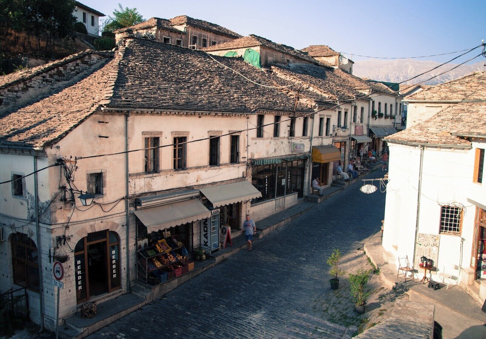 Gjirokastër (Albanian pronunciation: [ɟiɾokastəɾ]) is a city in southern Albania, on a valley between the Gjerë mountains and the Drino, at 300 metres above sea level. Its old town is a UNESCO World Heritage Site, described as "a rare example of a well-preserved Ottoman town, built by farmers of large estate". The city is overlooked by Gjirokastër Fortress, where the Gjirokastër National Folklore Festival is held every five years. It is the birthplace of former Albanian communist leader Enver Hoxha and notable writer Ismail Kadare. [from Wikipedia]