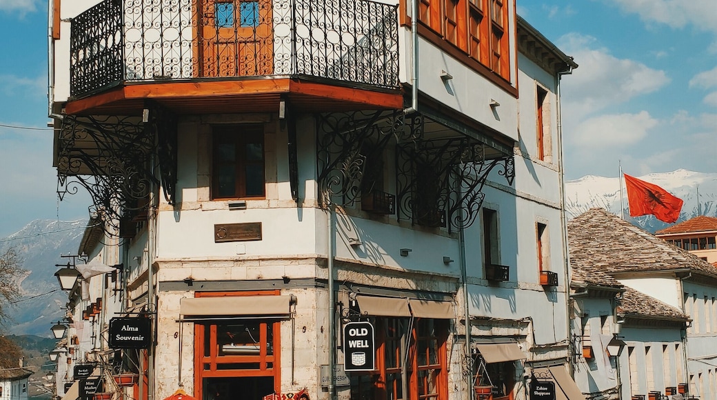 The old town of Gjirokastër, Albania: A main crossroad and this typical house which holds an old well on the ground floor (once a bar café today a souvenir shop).