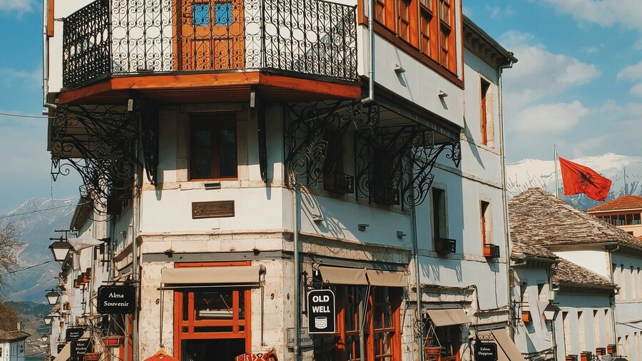 The old town of Gjirokastër, Albania: A main crossroad and this typical house which holds an old well on the ground floor