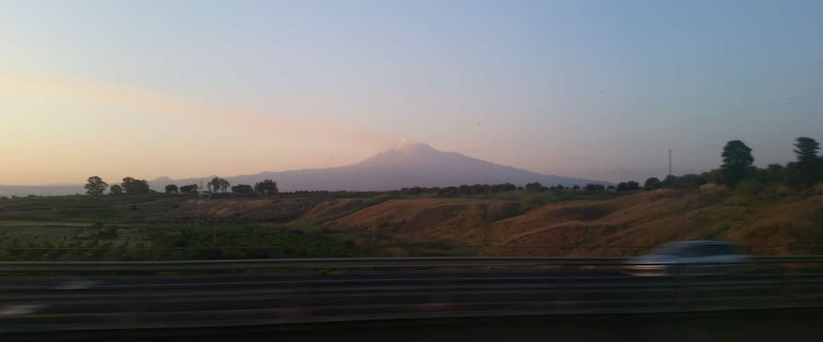 A mountain in the distance with a clear sky.