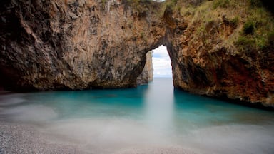 A natural rock formation with a clear water passage.