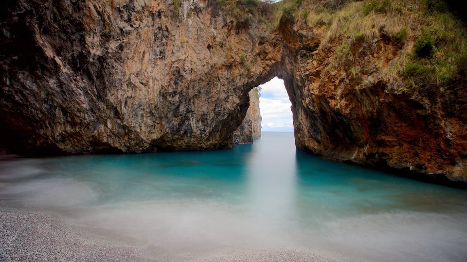 A natural rock formation with a clear water passage.