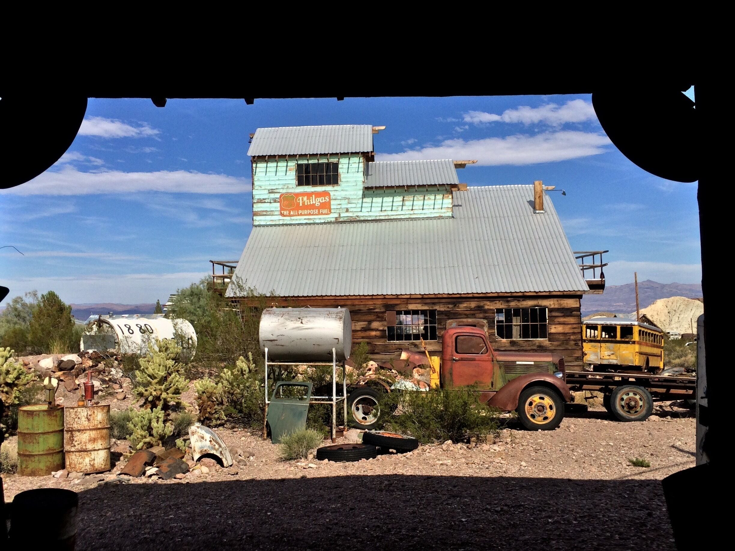 A dilapidated building with a sign reading "Philgas - The All-Purpose Fuel".