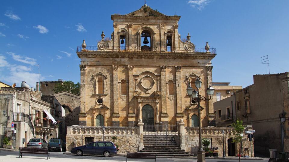 A historic church with a bell tower and a central dome.