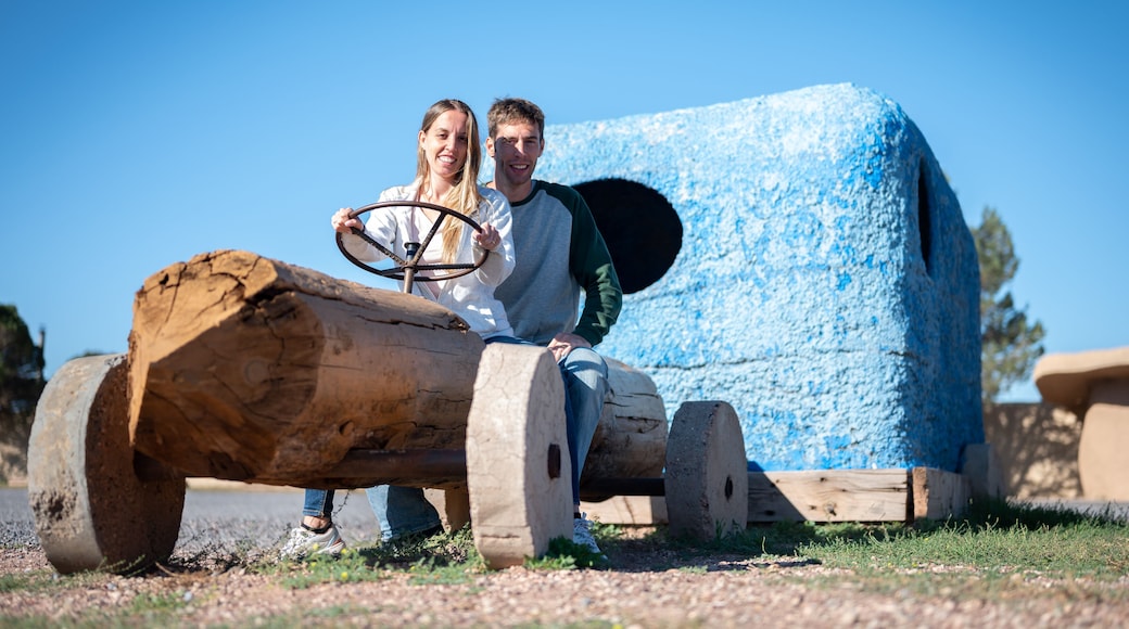 Young couple riding in the flintstones flintmobile