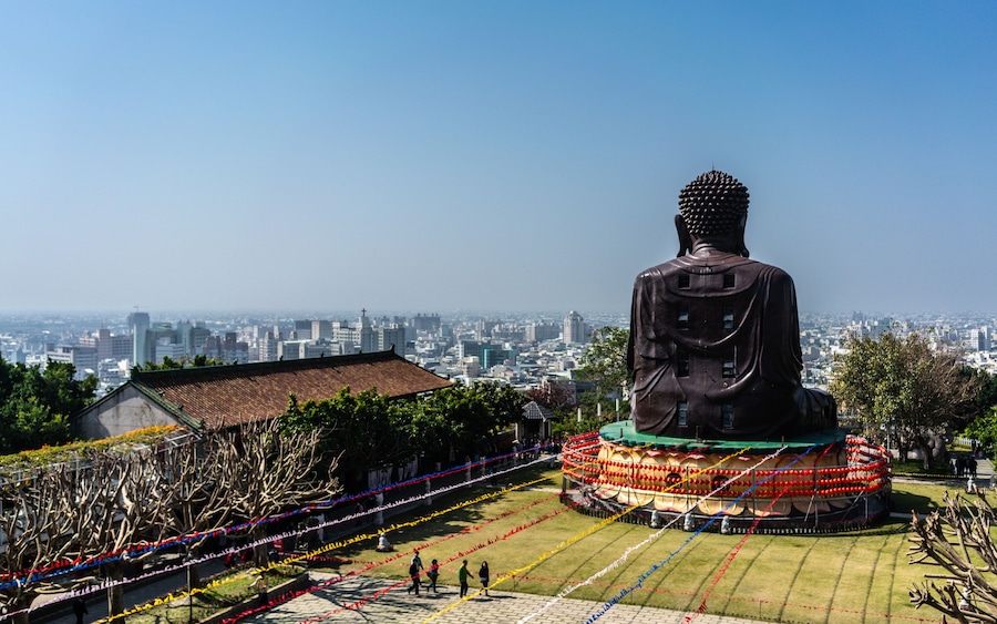 Baguashan great Buddha statue from mount Bagua and Changhua cityscape panorama in background in Taiwan