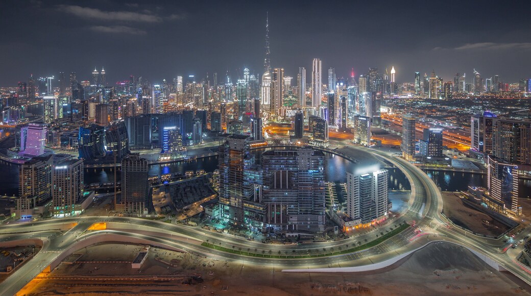 Panoramic skyline of Dubai with business bay and downtown district night timelapse.