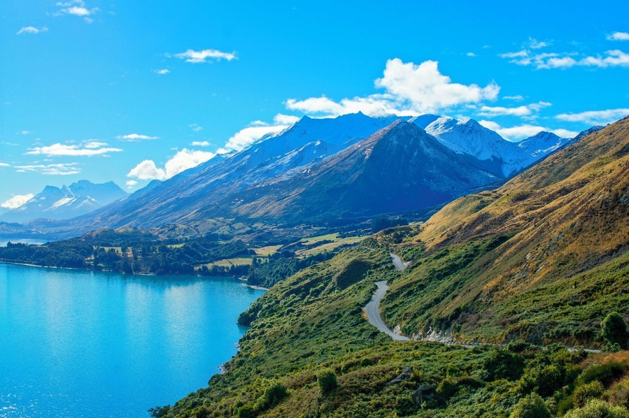 The drive from Queenstown to Glenorchy is by far my most favourite drive I've ever done, and it's gonna be really hard to beat that.
We were so lucky to visit Queenstown and Glenorchy in the middle of winter (June 2013, minus or 0 during the day, as crisp as you'd want your perfect winter to be) and have this absolute clear day with cracking blue skies.
The windy roads lead you through stunning green valleys, contrasted by clear blue lakes, majestic mountains topped with a crisp blanket of snow.