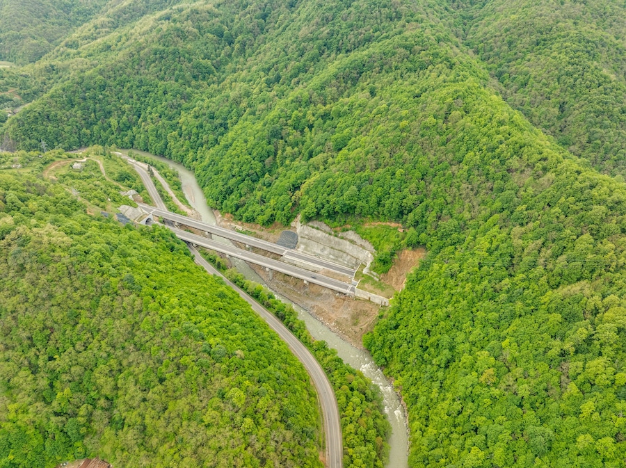 Aerial view of a quiet highway passing through a tunnels in a picturesque hilly region Rikoti Pass