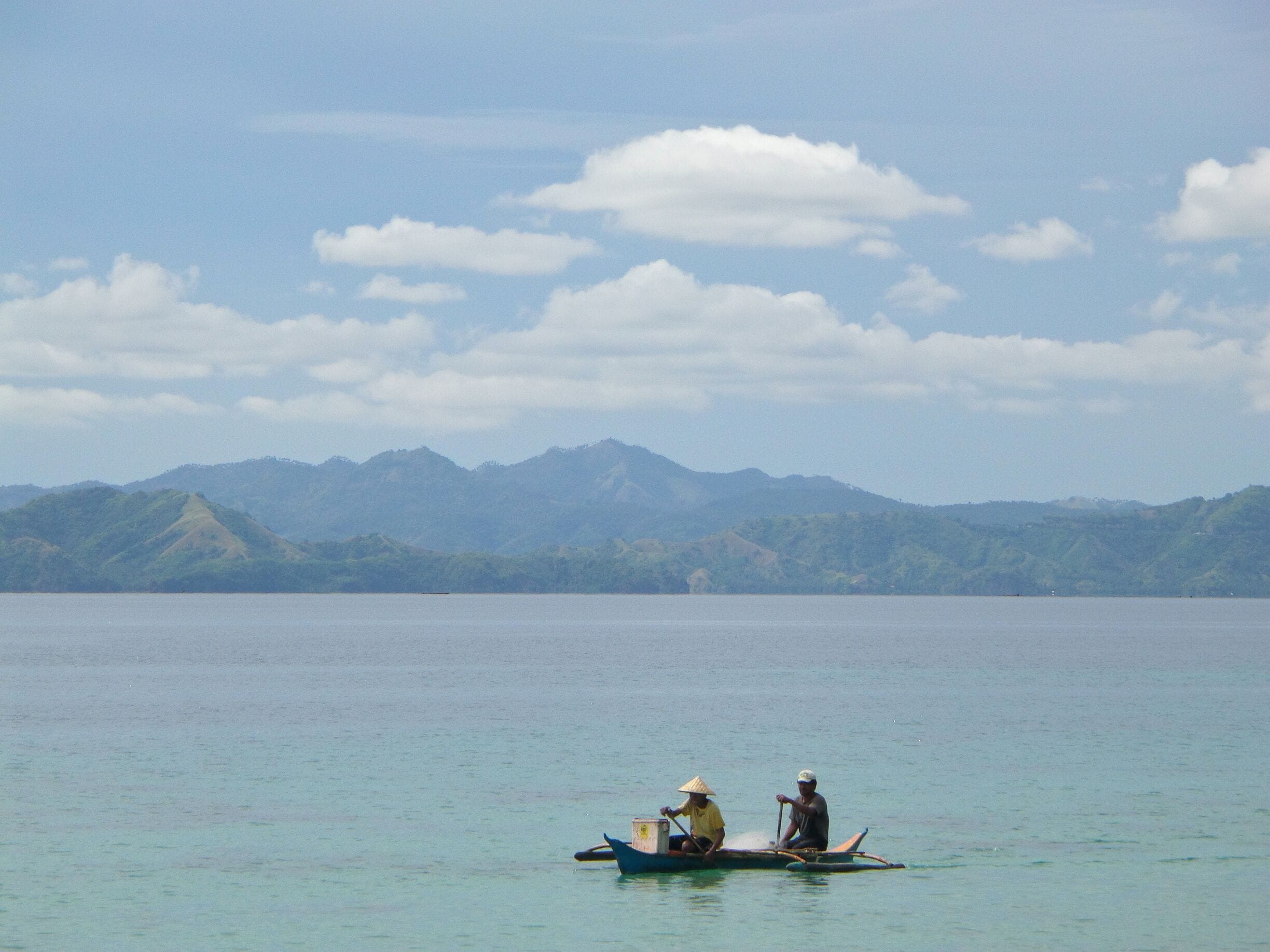 Arrived at our destination around noon. Since the sun is still making its way out of the coming dark clouds, I tried to enjoy the view then took a picture of these two fishermen.