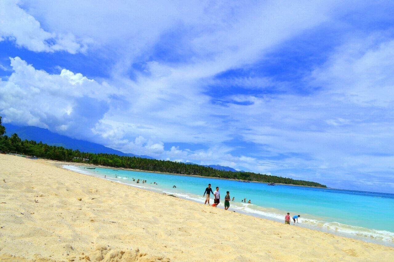 a very fine sand and very cool clear water that will embrace you on coming here in dahican beach, it takes less 10minutes from the town of mati , a motorcycle is a mode of transportation for a freelance traveler to reach the place. rooms to stay  are available though. #beachbound
