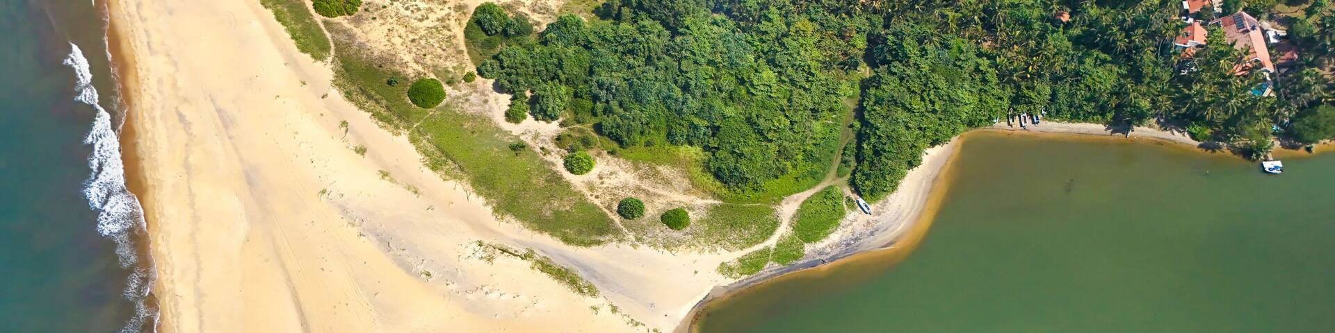 Aerial view of estuary with river Maha Oya flowing into Indian Ocean, Negombo, Sri Lanka.