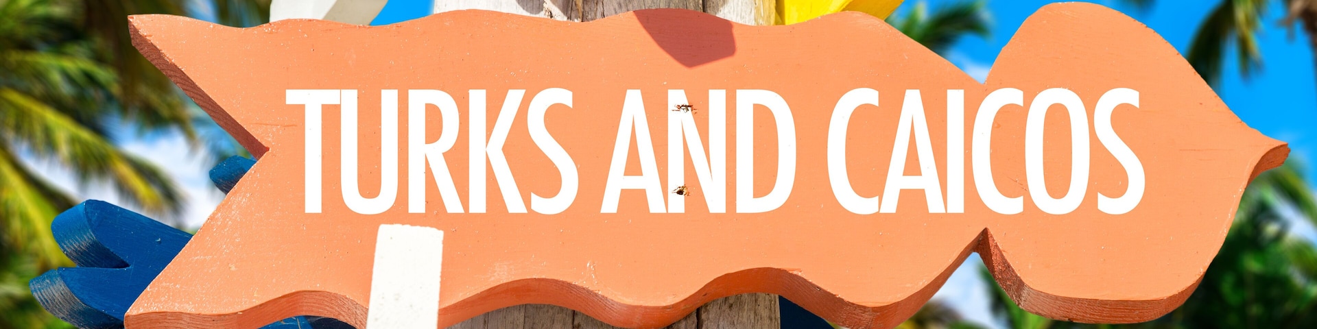 Turks and Caicos welcome sign with palm trees