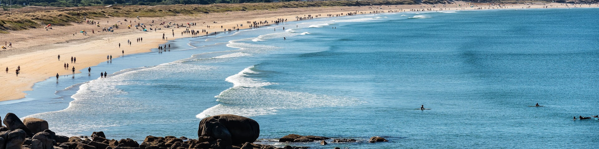 Person walking through the square and playing sports at dawn on a summer day, Grove, Galicia.