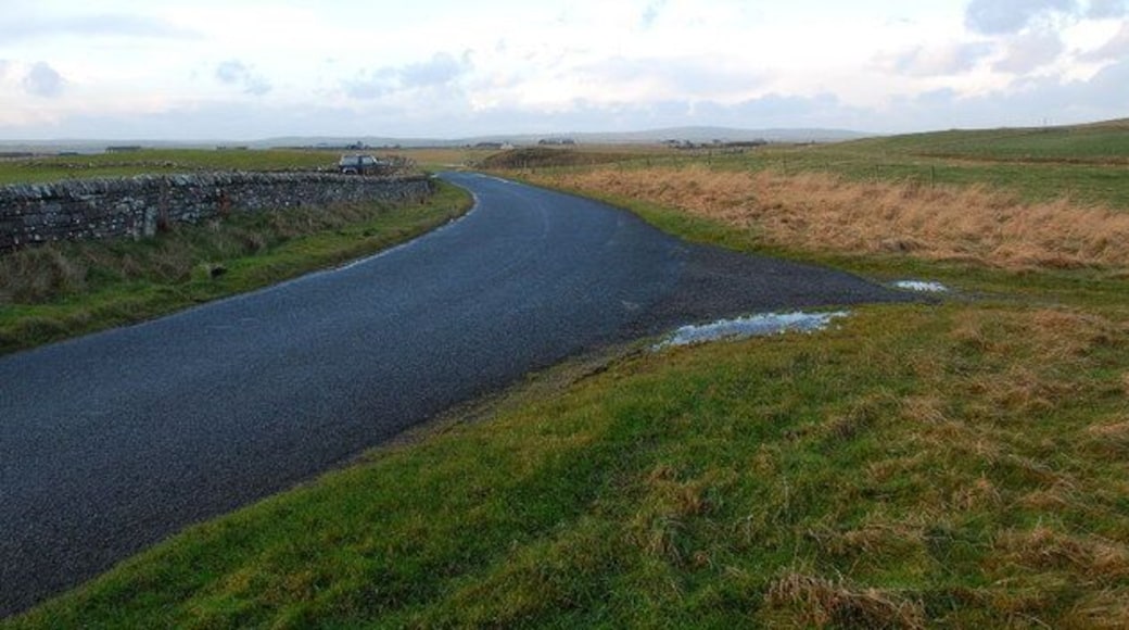 Track from Runas meets the lane to Russland Looking NW across the bend in the lane. The ten feet of tarmac at the start of the track is to give you a fighting chance of getting up it.