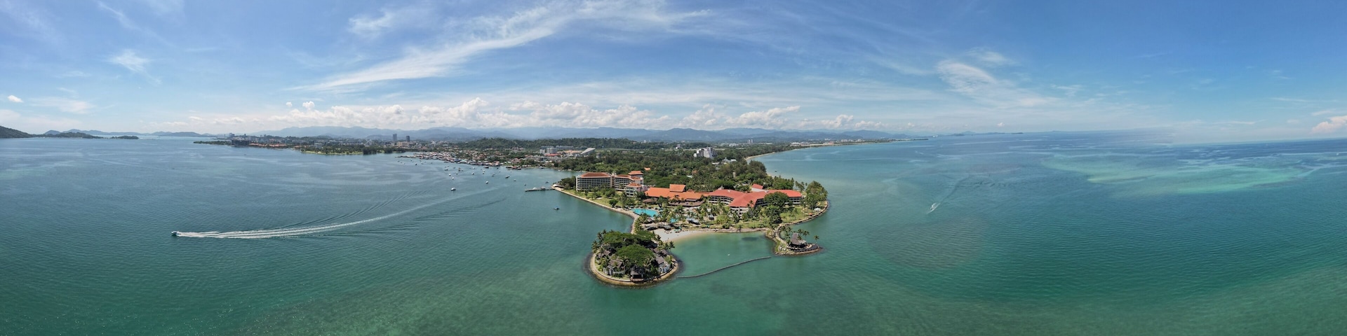 Kota Kinabalu, Sabah Malaysia – June 15, 2022: The Tanjung Aru Beach, Fisherman Village and Shangri-La Hotel