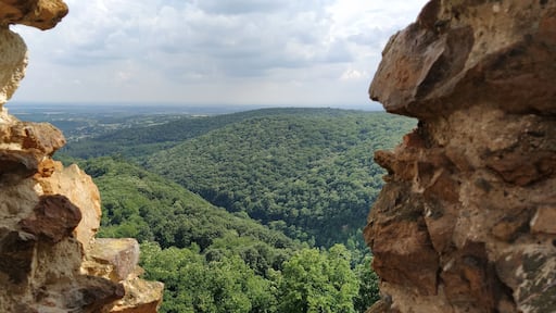 Ruins of an old fortress in Vrdnik, Sremska Mitrovica, Vojvodina, Serbia. Ancient stone walls with mountain ranges in the background. Tourist sights. Embrasure or window for observation and defense