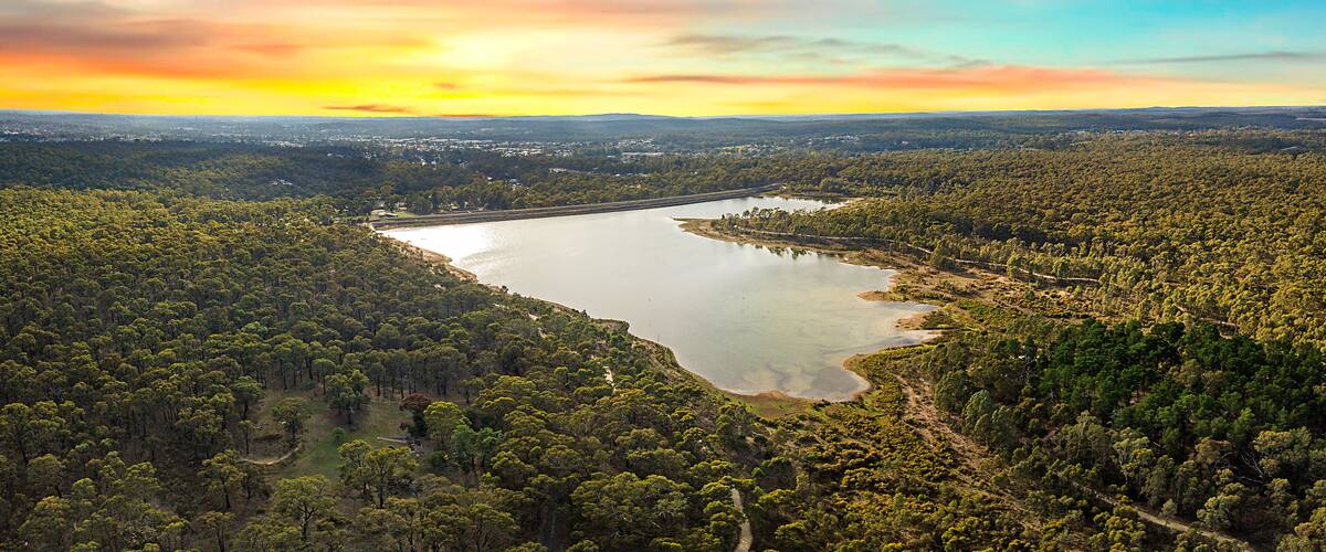 Sunrise at Crusoe Reservoir, Bendigo. Dramatic red skies over luscious green forest, pristine nature and open landscapes in Central Victoria.