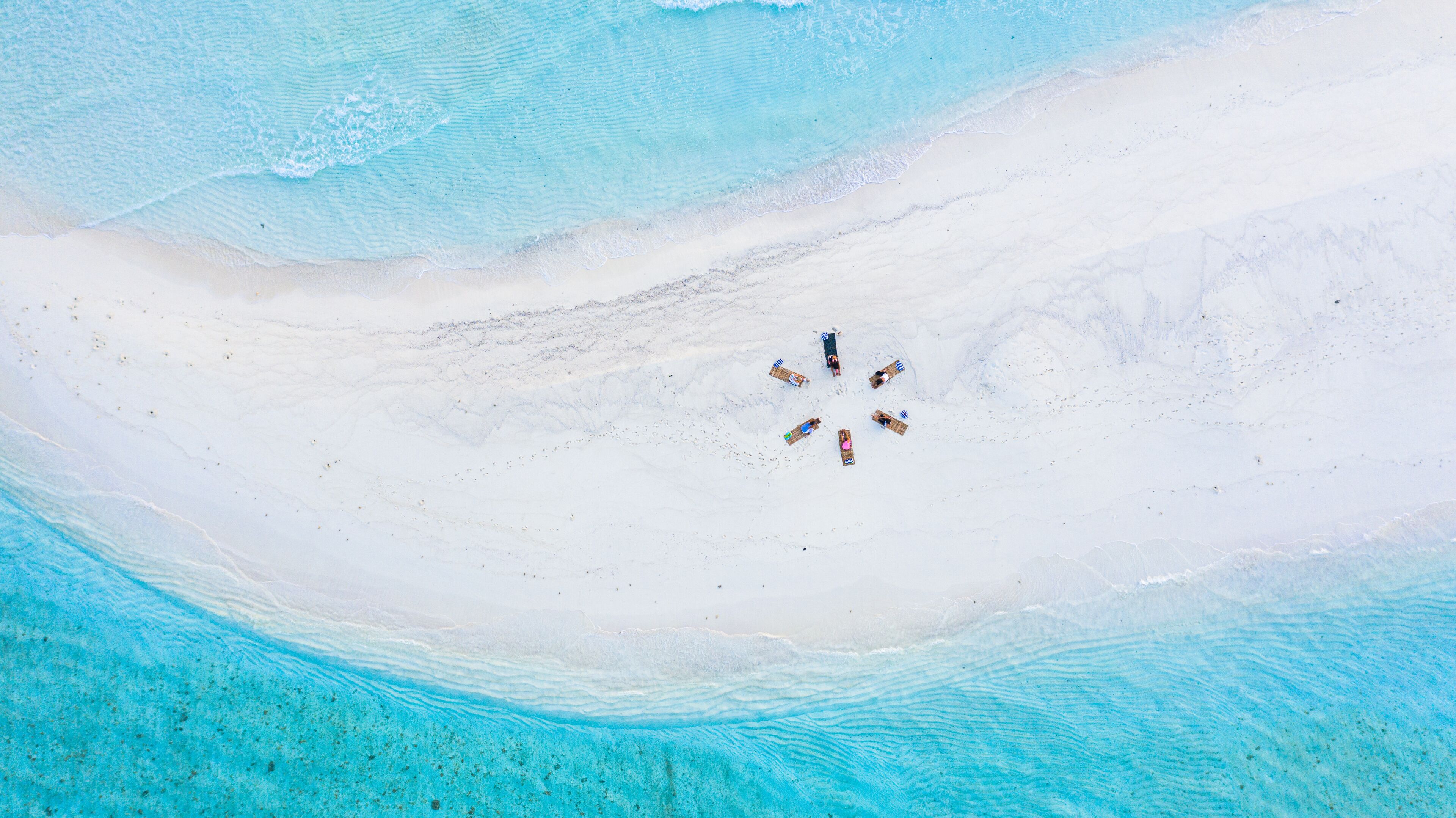 Aerial view of a group of women, doing yoga at a sandbank, Maldives.