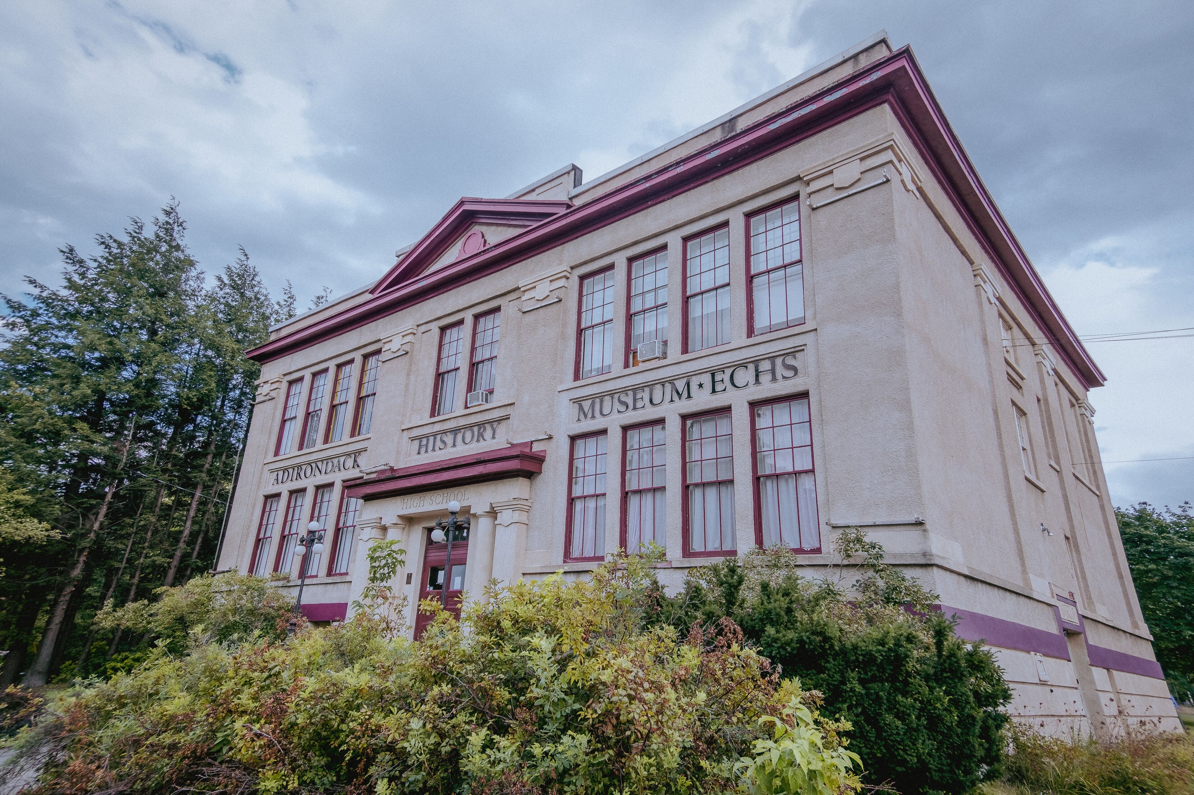 A historic building with 'Adirondack High School' and 'Museum ECHS' signs.