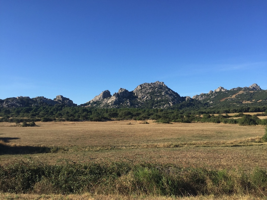 A mountainous landscape with a clear blue sky.