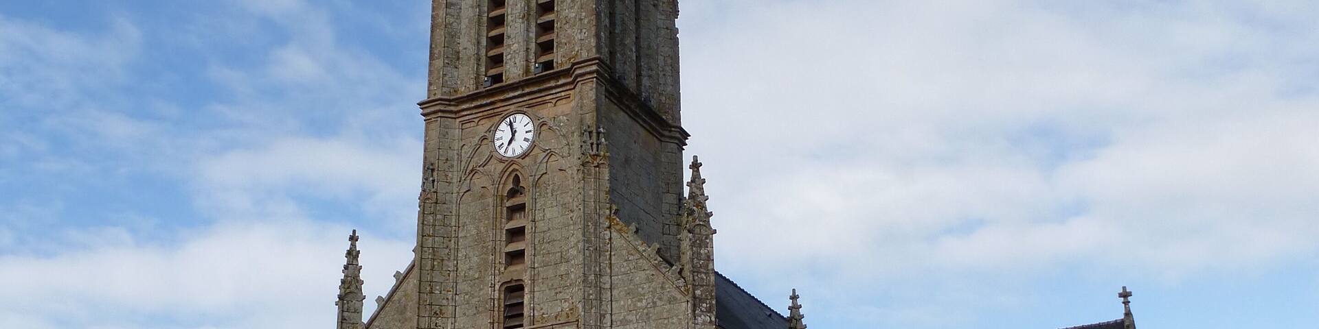 A historic church with a tall spire and a clock tower.