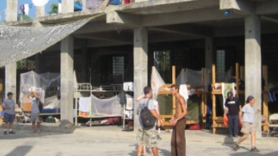 A construction site with concrete pillars and a partially built structure.