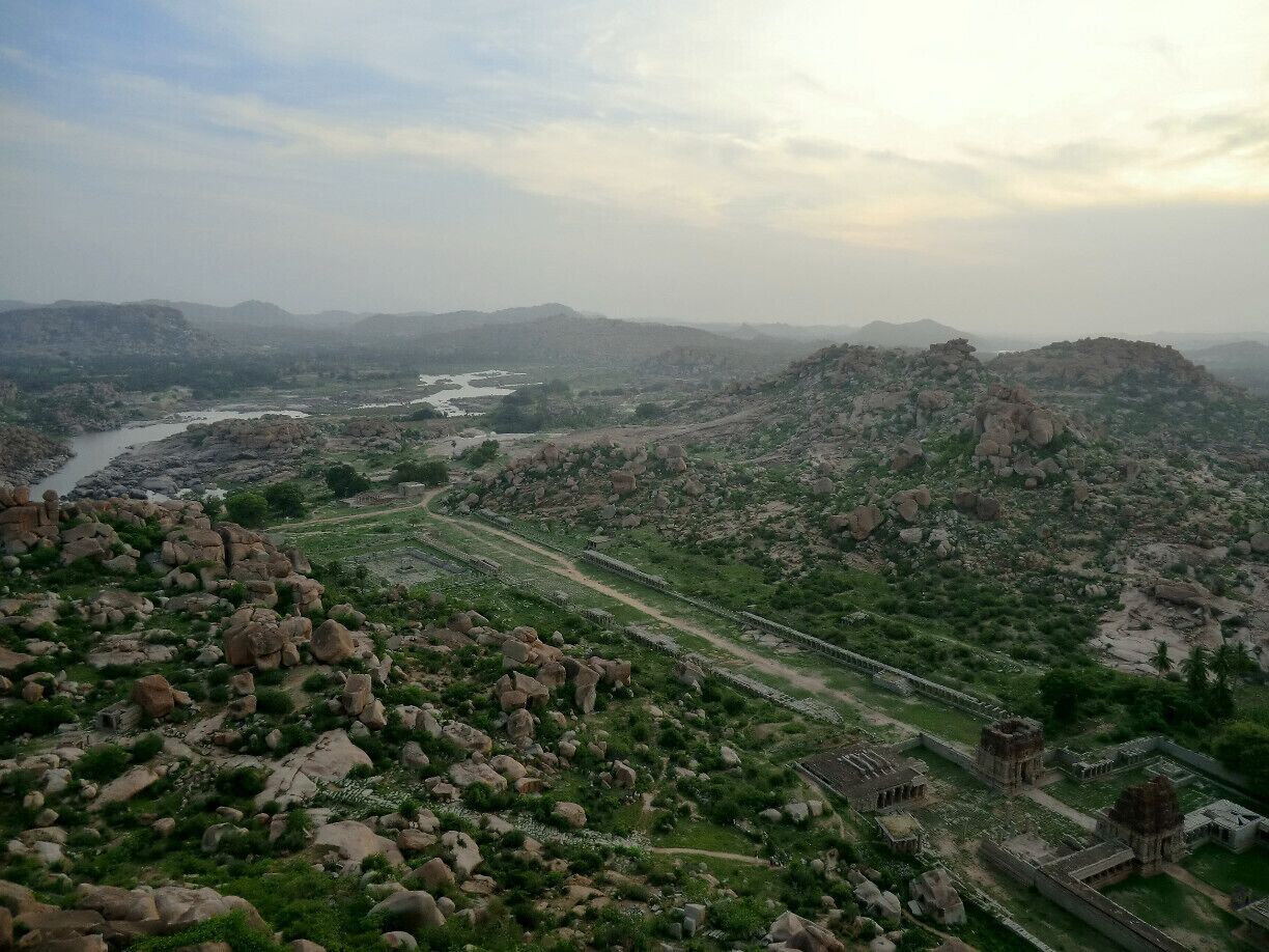 The view over Hampi at sunrise is totally worth the climb (about 15-20min).

Hampi is a very peaceful place, we went there off season (late spring) and stayed for a few days to unwind. We rented bicycles to wander around the valley and its beautiful temples. Paths are well signed and easy to follow, but remember to carry some water.
#bicycle