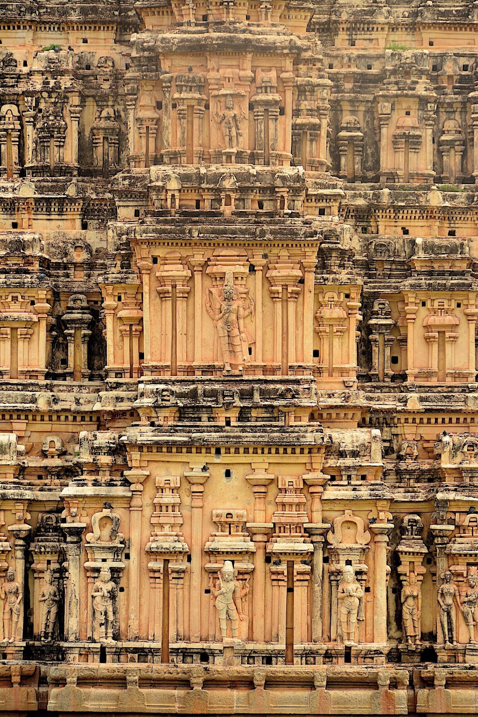 A detailed stone temple with intricate carvings and multiple statues.