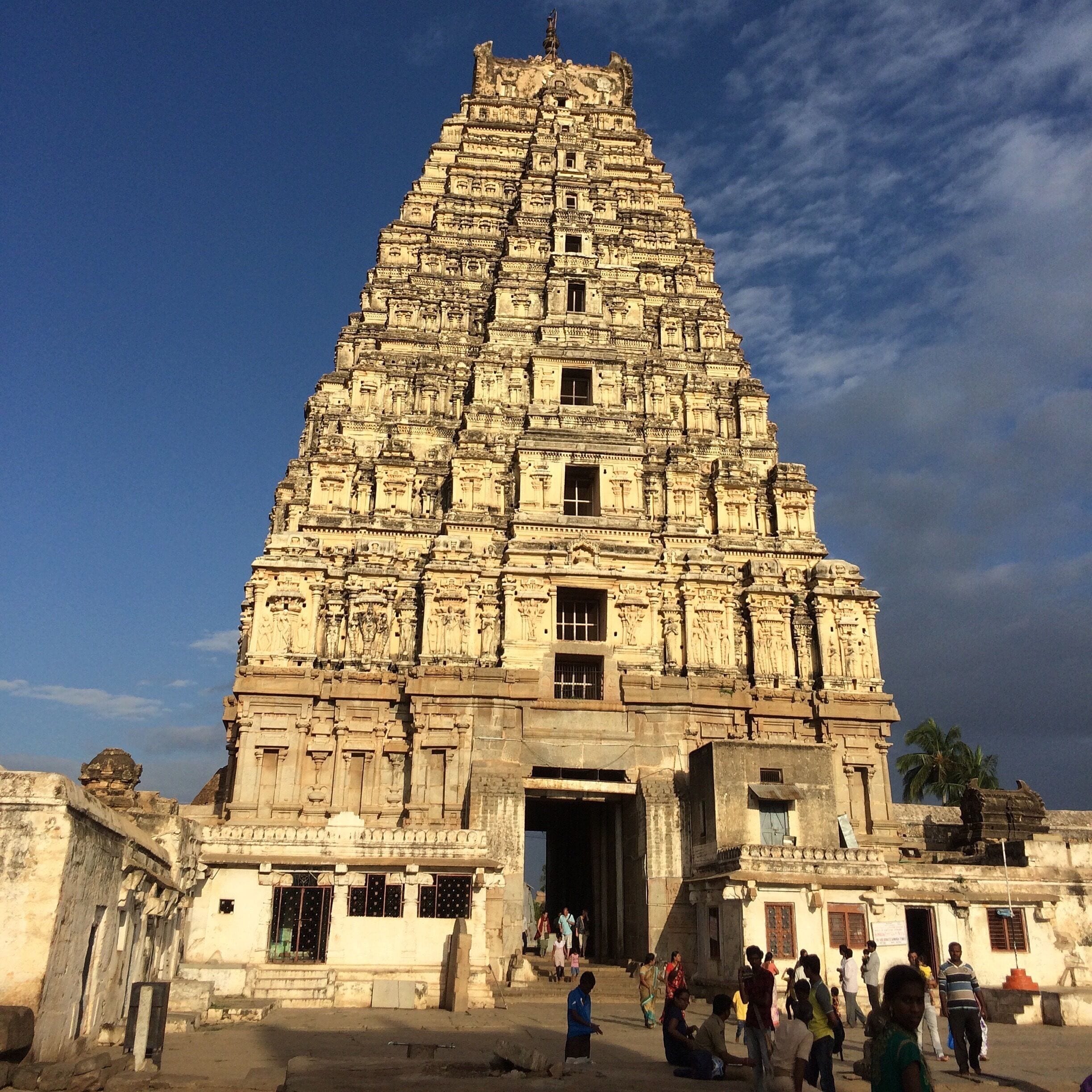 A large, intricately carved temple with multiple tiers and statues.