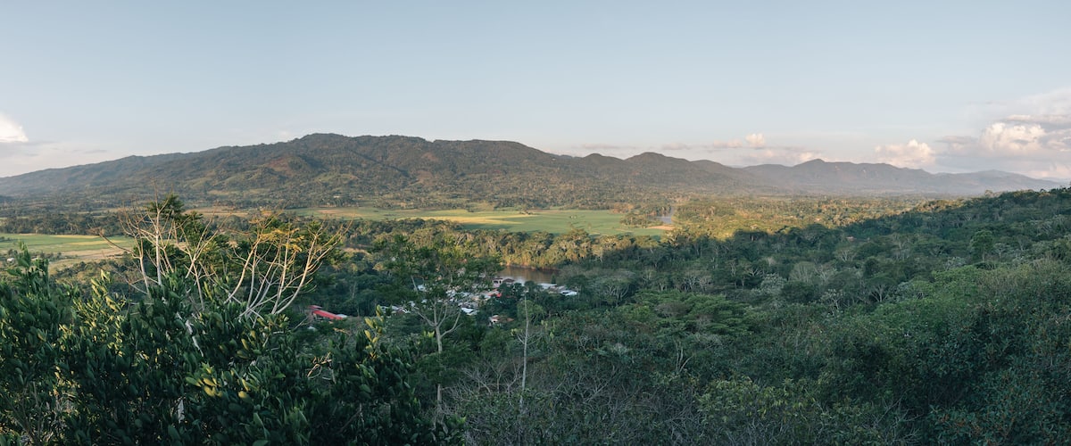 A mountainous landscape with a village nestled in the valley.
