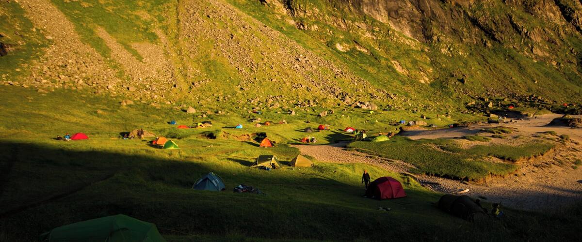 #beachtips
If a wild camping paradise exists, it would be on Kvalvika Beach on the Lofoten Islands in Norway. This place can only be reached on foot, after doing a mountain hike, and is always packed with wild campers who come there to enoy the midnight sun. I shot this photo in July 2017, around midnight, when the sun was at its lowest point and shade was covering parts of the beach.