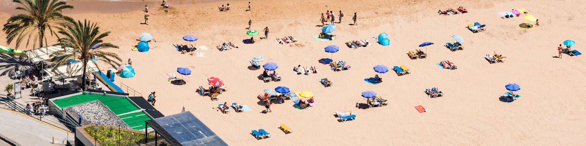 Portugal, Madeira, Calheta, High angle view of people relaxing on sandy coastal beach in summer