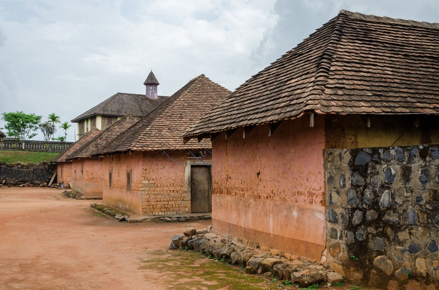 Traditional palace of the Fon of Bafut with brick and tile buildings and jungle environment, Cameroon, Africa