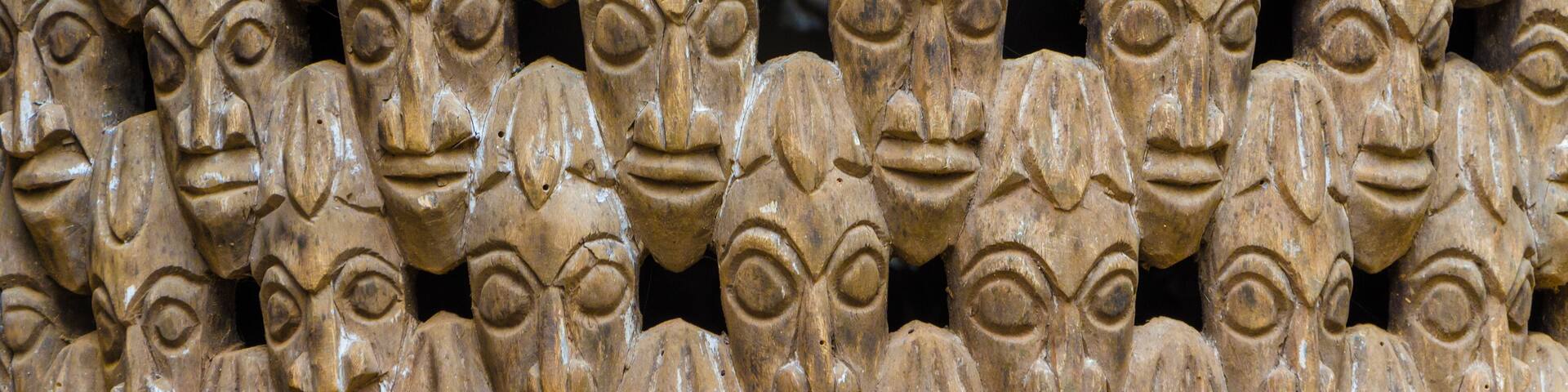 Pattern of many wood carved heads on chair at traditional Fon's palace in Bafut, Cameroon, Africa