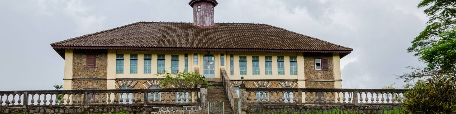 Museum at traditional palace of the Fon of Bafut with brick and tile buildings and jungle environment, Cameroon, Africa