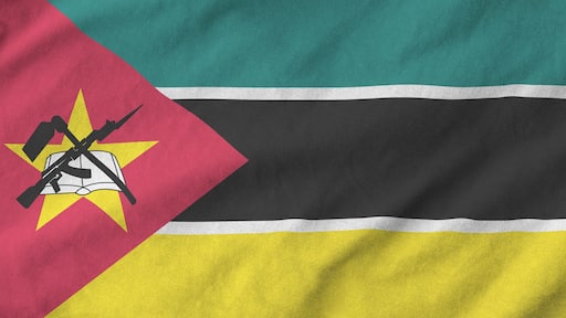 Mozambique flag depicted on folded wavy fabric of old cloth close up