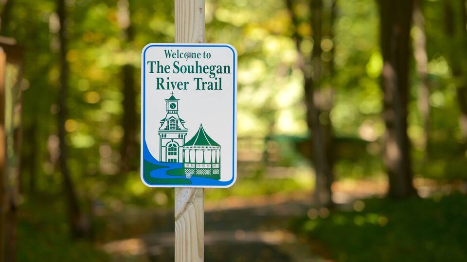 A welcome sign for The Souhegan River Trail with a church and a gazebo illustration.
