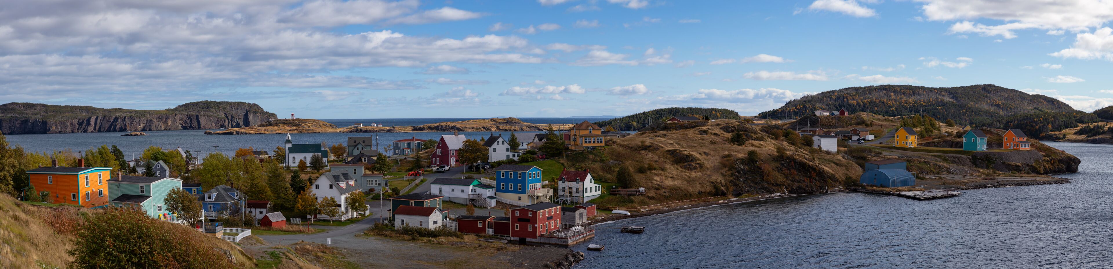 Aerial panoramic view of a small town on the Atlantic Ocean Coast during a sunny day. Taken in Trinity, Newfoundland and Labrador, Canada.