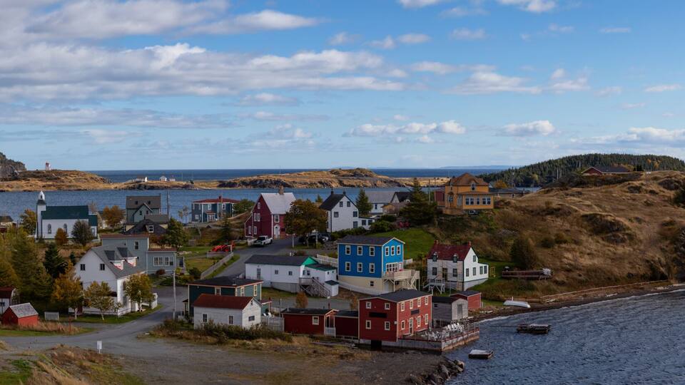 Aerial panoramic view of a small town on the Atlantic Ocean Coast during a sunny day. Taken in Trinity, Newfoundland and Labrador, Canada.