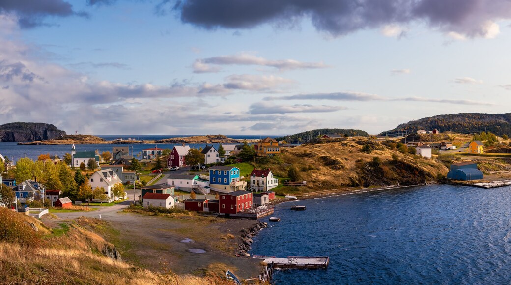 Panoramic view of a small town on the Atlantic Ocean Coast. Dramatic Colorful Sunrise Sky Art Render. Taken in Trinity, Newfoundland and Labrador, Canada.